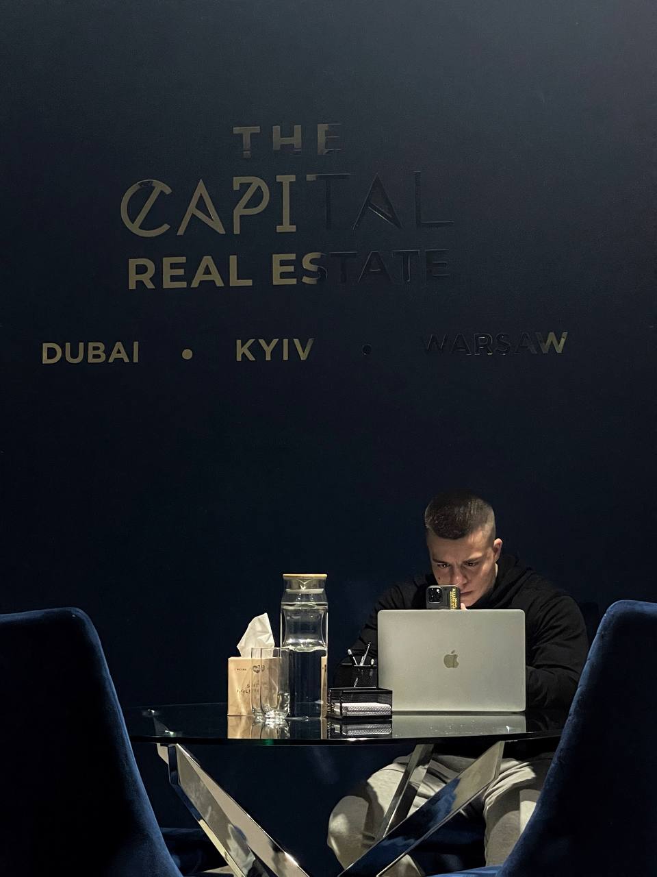 Author working at The Capital Real Estate office